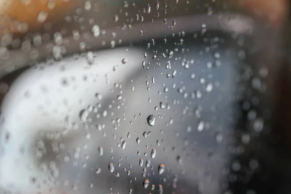 Rainy rain with rain on car glass background blurred