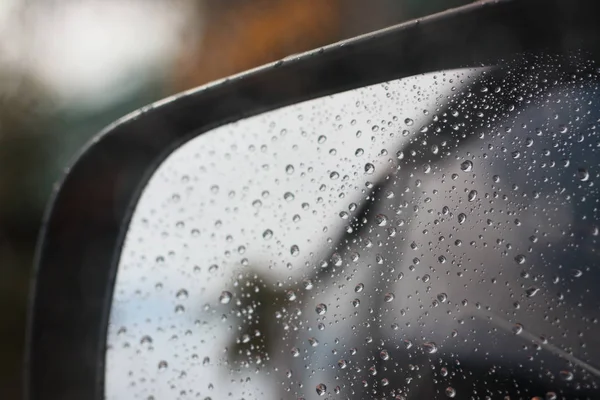 Rainy rain with rain on car glass background blurred