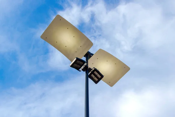 Modern street lighting against a cloudy sky background