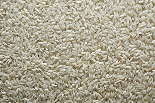 Achtergrond van rijst. Rijst-patroon. Rijst korrels close-up. Bovenaanzicht — Stockfoto