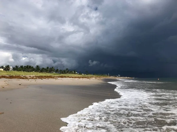 Storm rolling onto the beach with dark clouds and destruction