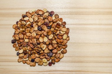 Meyve çekirdekleri kül belirgin bir doku ile ahşap bir masa hafif bir arka plan üzerinde bir daire şeklinde yerleştirilir. Arka plan. Yer metin çizme