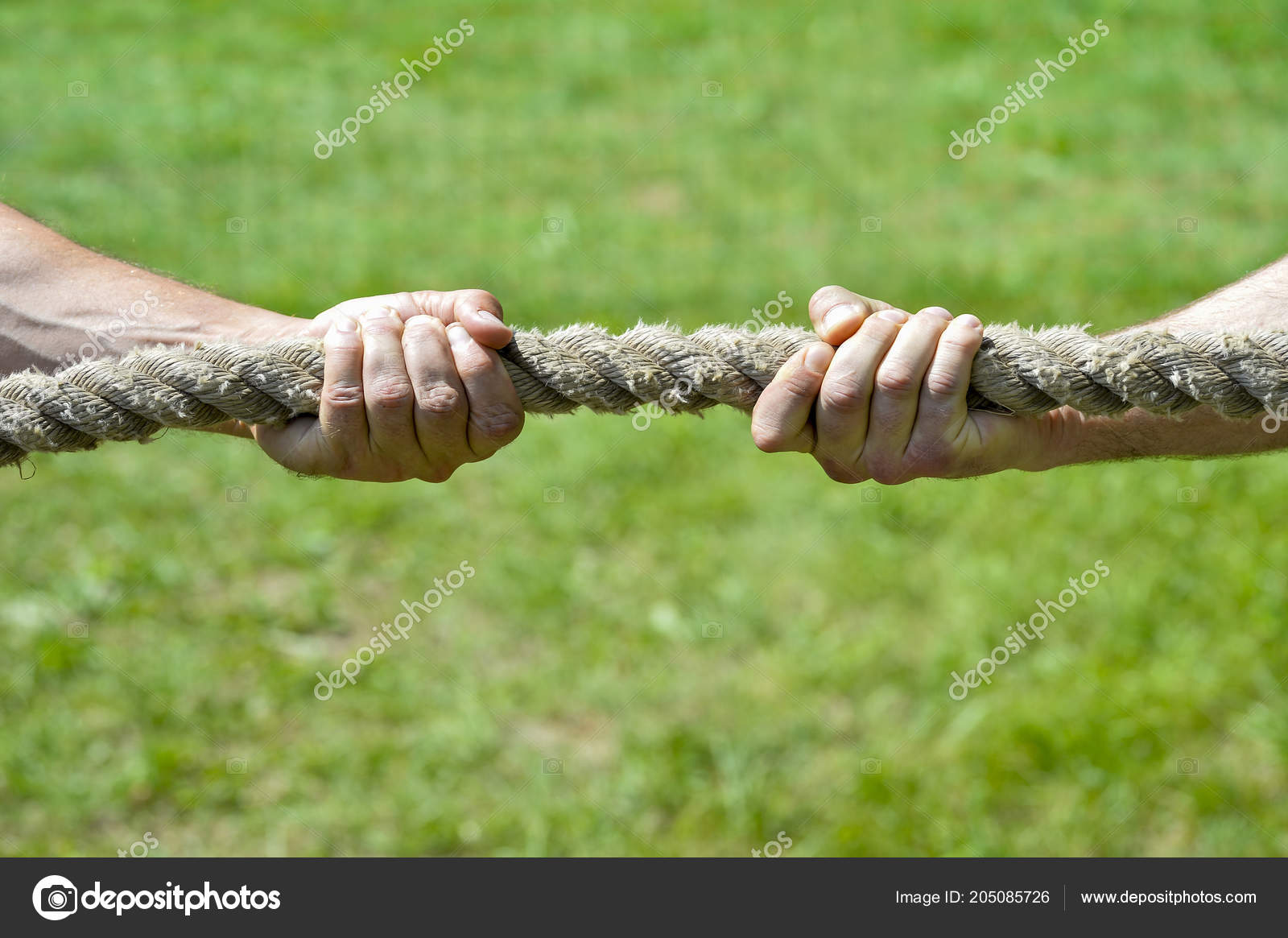 Two Men's Hands Pull Rope Each His Own Direction Concept