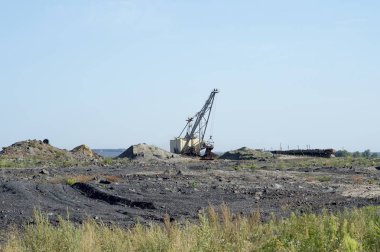 Büyük bir ekskavatör boş tren kaya taşır. Üçüncü dünya ekonomisi kavramı: madencilik ve çevre sorunları. Doğa adam tarafından imha sonra sanayi peyzaj.