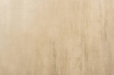 Eski bir ev yıpranmış sıva ve beton tezahürü ile bej boyalı duvar. Arka plan.