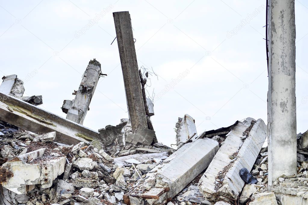 Remains of the destroyed industrial building. Large concrete piles continue to hold the body of the large concrete buildings, while others look at the sky.