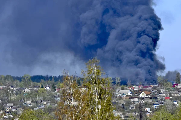 Smoke from a fire on the outskirts of the city in the private sector.