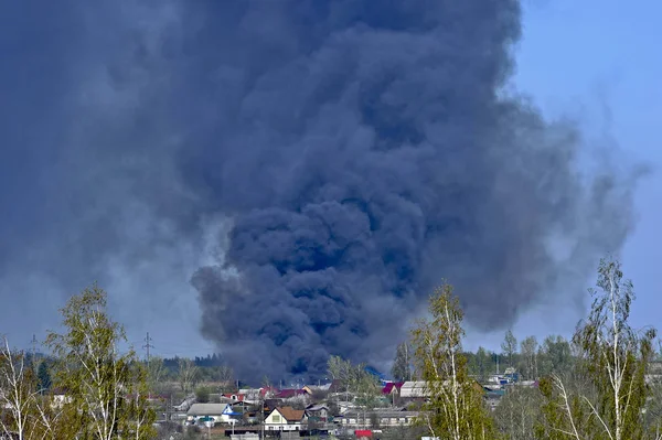 Smoke from a fire on the outskirts of the city in the private sector.