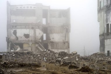 Bina yığınları ve moloz taş bir sisli sis yok yapısında arka plan üzerine beton parçaları bir yığın şeklinde tahrip temeli kalıntıları.