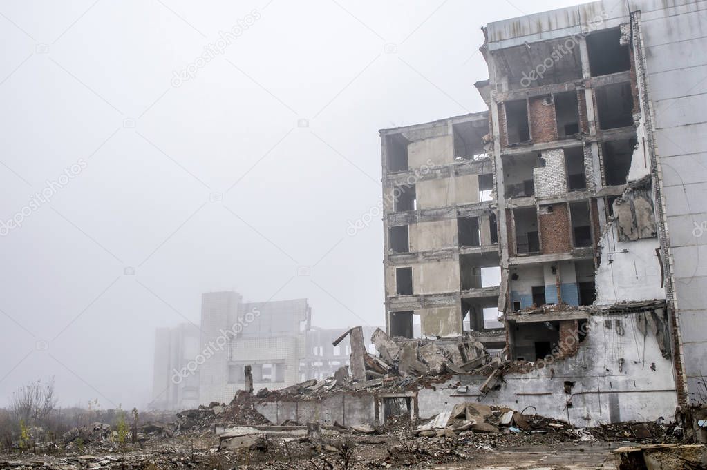 The remains of a large concrete building in the form of fragments of piles and piles of stones. Copy space.