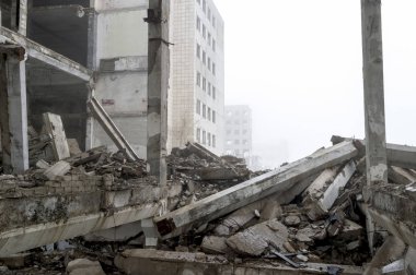 Sisli bir sis içinde yıkılmış büyük beton bina. Arka plan.