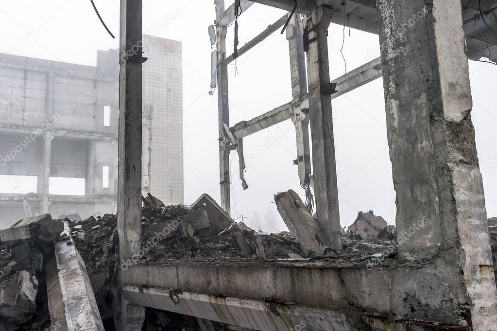 The destroyed big concrete building in a foggy haze. Background.