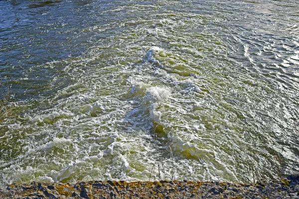 Blick von oben auf den brodelnden Bach unterhalb des Staudamms am Fluss im — Stockfoto