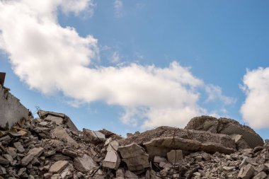 Mavi gökyüzüne karşı yıkılan bir binanın beton parçaları. Arkaplan.