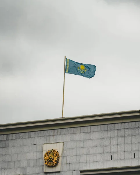 Flag of Kazakhstan on a cludy day on top of a building