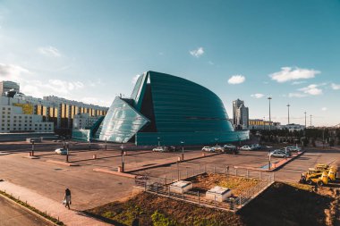 Astana, Kazakhstan - July 2018: located in the administrative center, unique in its architectural design, the biggest concert of the capital structure clipart