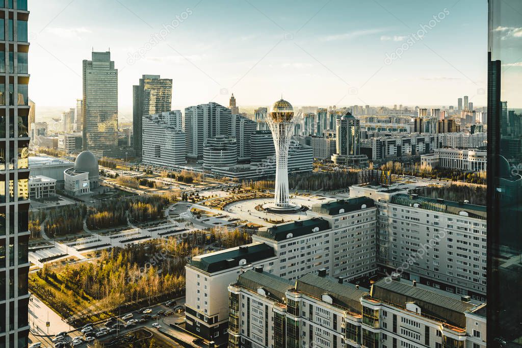 Sunset view towards Bayterek tower and hous of ministries in Astana Kazakhstan on a clear day