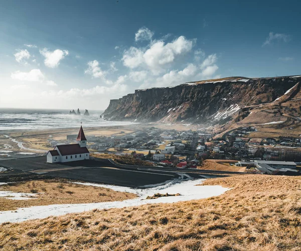Panoramic view of the Vik at sunrise sunset . South Iceland.Typical red colored wooden church in Vik town, Iceland in winter. — Stock Photo, Image