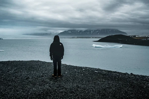 若い男が霧の日に南アイスランドの jokursarlon 氷河湖を見下ろす — ストック写真