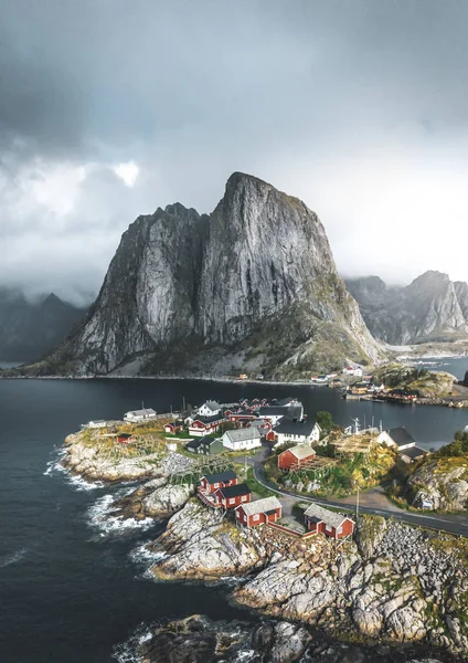 有名な観光の魅力ハムネイの漁村のロフォーテン諸島ノルウェー、レーヌの近くに赤いがりとパノラマの秋雲と青い空と海の波の家します。. — ストック写真