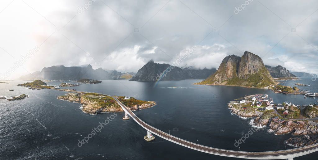 Aerial panoramic view of Reine traditional fishing village in the Lofoten archipelago in northen Norway with blue sea and mountains during sunny arctic summer
