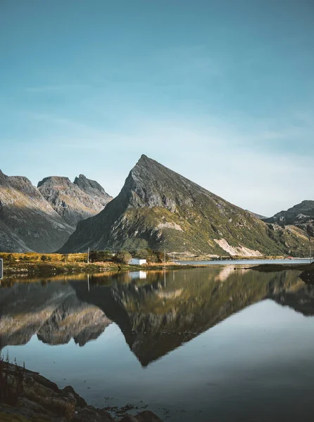 The stunning maointain near Fredvang in Lofoten Islands, Norway seen from a drone aerial with reflection on a clear day with blue sky. — Stock Photo, Image