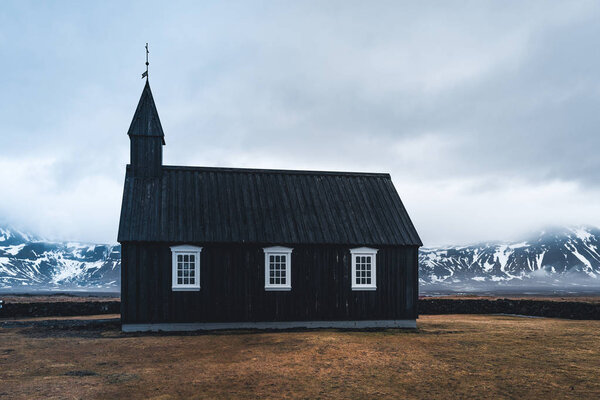 Famous picturesque black church of Budir at Snaefellsnes peninsula region in Iceland during a heavy snowy weather. Photo taken in Iceland.