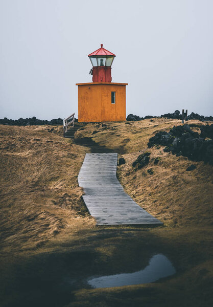 Orange Lighthouse Svortuloft Skalasnagi tower in Snaefellsnes Peninsula, west Iceland on an overcast day. Royalty Free Stock Images