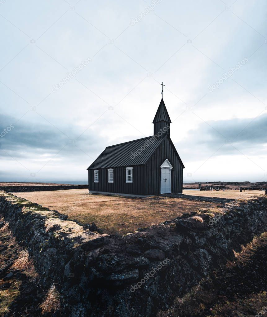 Famous picturesque black church of Budir at Snaefellsnes peninsula region in Iceland during a heavy snowy weather