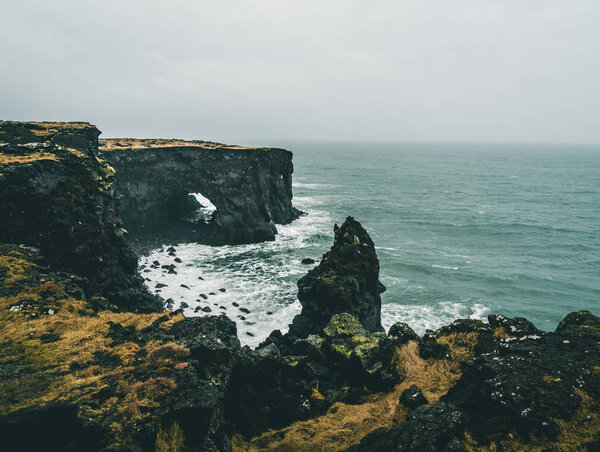 Orange Lighthouse Svortuloft Skalasnagi tower in Snaefellsnes Peninsula, west Iceland on an overcast day.