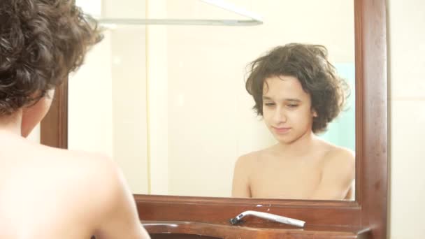 Cute Boy Brushing His Curly Hair In Front Of The Bathroom Mirror 4k