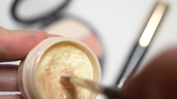 Närbild. 4k, slowmotion. Womens händer smeta en make-up borste med en färglös läppglans. — Stockvideo