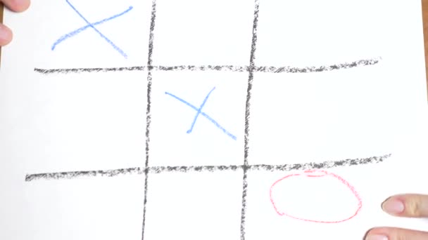 Time-lapse. 4k, close-up, top view. Tic Tac Toe blue with a red pencil. male and female hand. the concept of rivalry between a man and a woman. — Stock Video