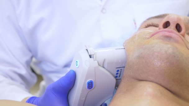 Lifting facial no quirúrgico. SMAS levantando ultrasonidos. El proceso de rejuvenecimiento. Cosmetología de hardware. contorno de cara de plástico. manos de un dermatólogo médico hacer un hombre un ultrasonido lifting facial — Vídeos de Stock