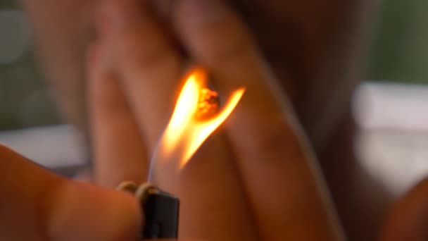 un gros plan, un homme allume une cigarette. 4k, au ralenti 