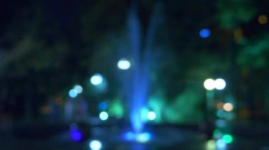 bir çeşme akşamları renkli su aydınlatma ile. yakın çekim, bulanıklık, 4k