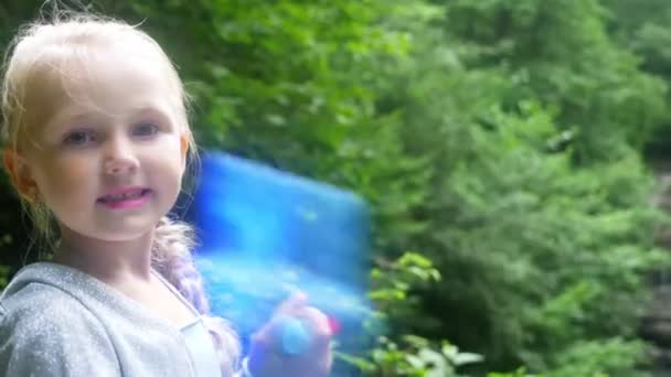 Little girl model in a beautiful blue dress posing in a forest. 4k, slow motion — Stock Video