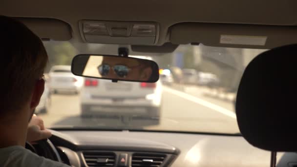 Atasco de coches en una carretera concurrida en un día soleado brillante, vista desde el coche, borroso. 4k, cámara lenta — Vídeo de stock