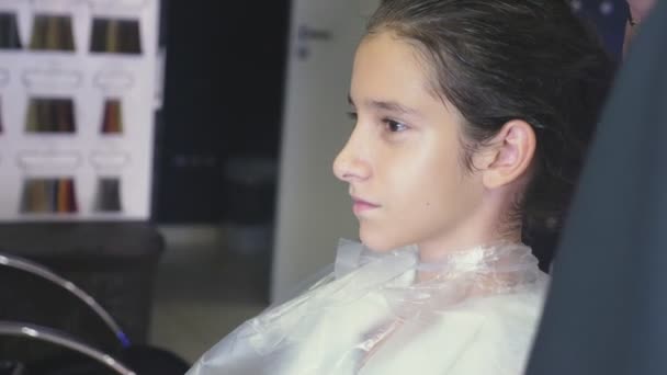 Close-up, Cabeleireiro profissional. processo de pintar o cabelo de uma menina morena com um tónico tonificante para o cabelo. secagem de cabelo com secador de cabelo, câmera lenta — Vídeo de Stock