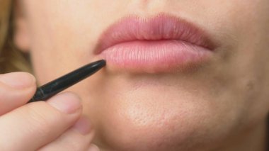 super close-up, a woman paints her lips with a pencil for her lips. lip makeup, dermatological disease on the skin of the lips. Fox Foxes granules clipart