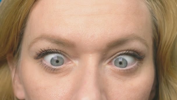 Beautiful eyes, close-up. A young woman blinks and looks at the camera. woman squints eyes to nose. humor. 4k, close, slowdown — Stock Video