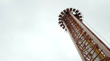 Drop tower. With most drop towers, a gondola carrying riders is lifted to the top of a large vertical structure, then released to free-fall down the tower. Sochi park. September 2017. clipart