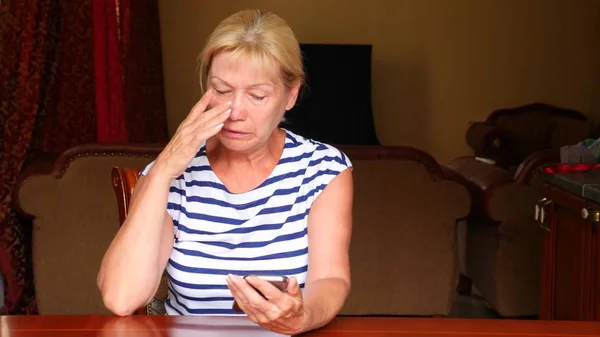 Strong emotional breakdown of an adult woman who read a message on the smartphone. copy space