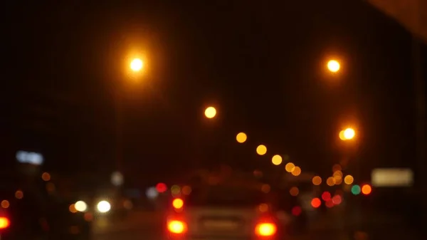Водіння вночі. розмиті автомобілі в місті. Вікно переднього автомобіля з розмитим міським рухом на міських вулицях . — стокове фото