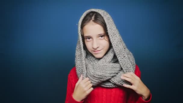 Beautiful teen girl in autumn clothes , posing at camera over blue background — Stock Video