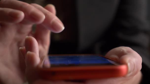 Крупним планом, жіночі пальці на сенсорному екрані смартфона. жінка використовує мобільний телефон — стокове відео