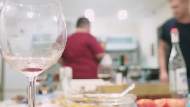 Conceito de uma festa em casa. refeições com alimentos na mesa de férias em foco, as pessoas em segundo plano são turvas . — Vídeo de Stock