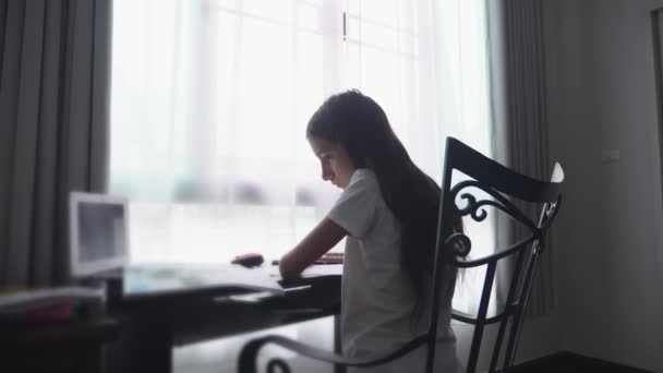 Adolescente haciendo deberes para la escuela en su habitación, en el escritorio — Vídeo de stock