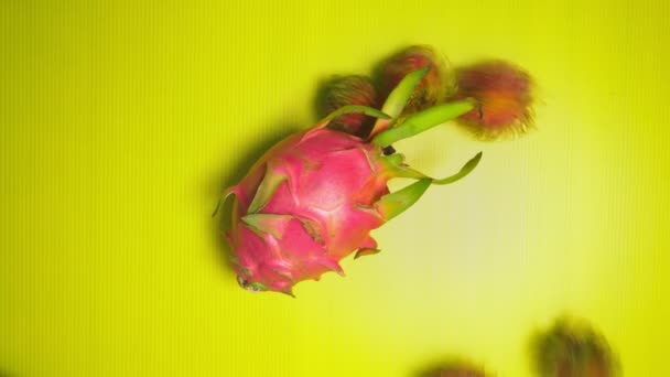 Rambutan, dragon fruit . fruits on a bright yellow background. Minimal fruit concept. — Stock Video