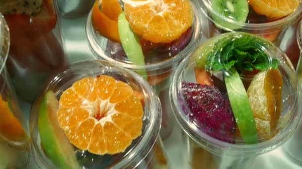 Asian street food concept. Thailand. fruit in cups, sliced for making smoothies on the rack of an outdoor kiosk. — Stock Video